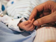 baby holding hand hospital